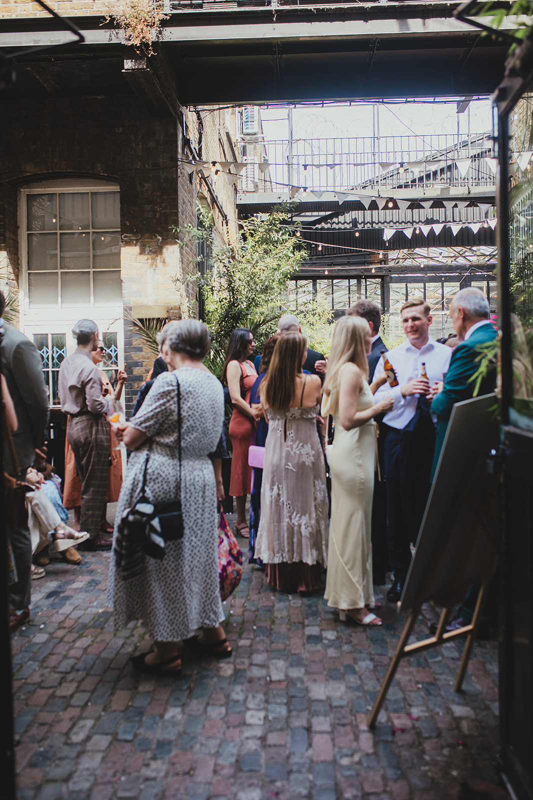 Wedding guests in the court yard at The Depot N7 wedding reception, London wedding