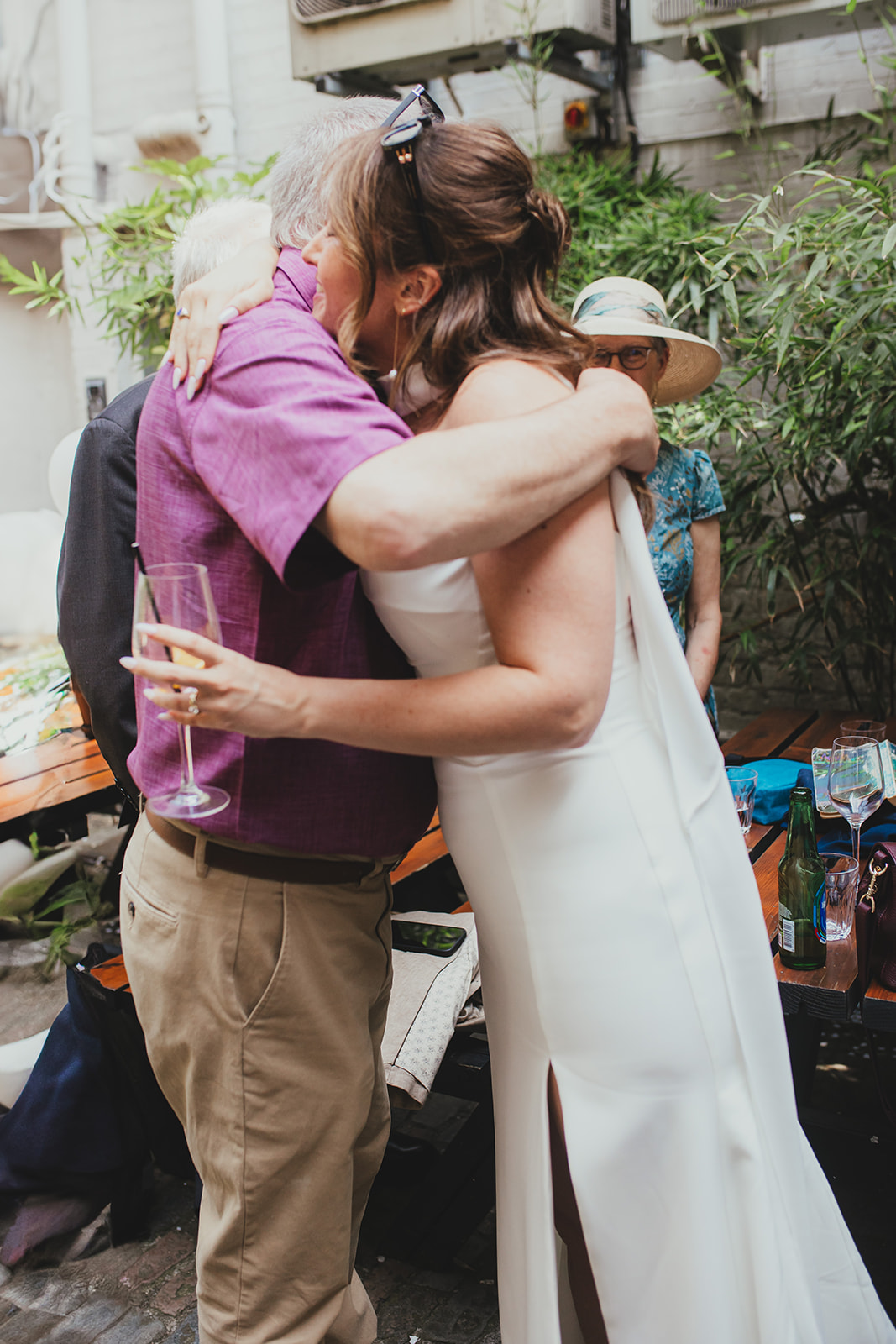 Bride embracing guest at wedding reception at The Depot N7, London wedding