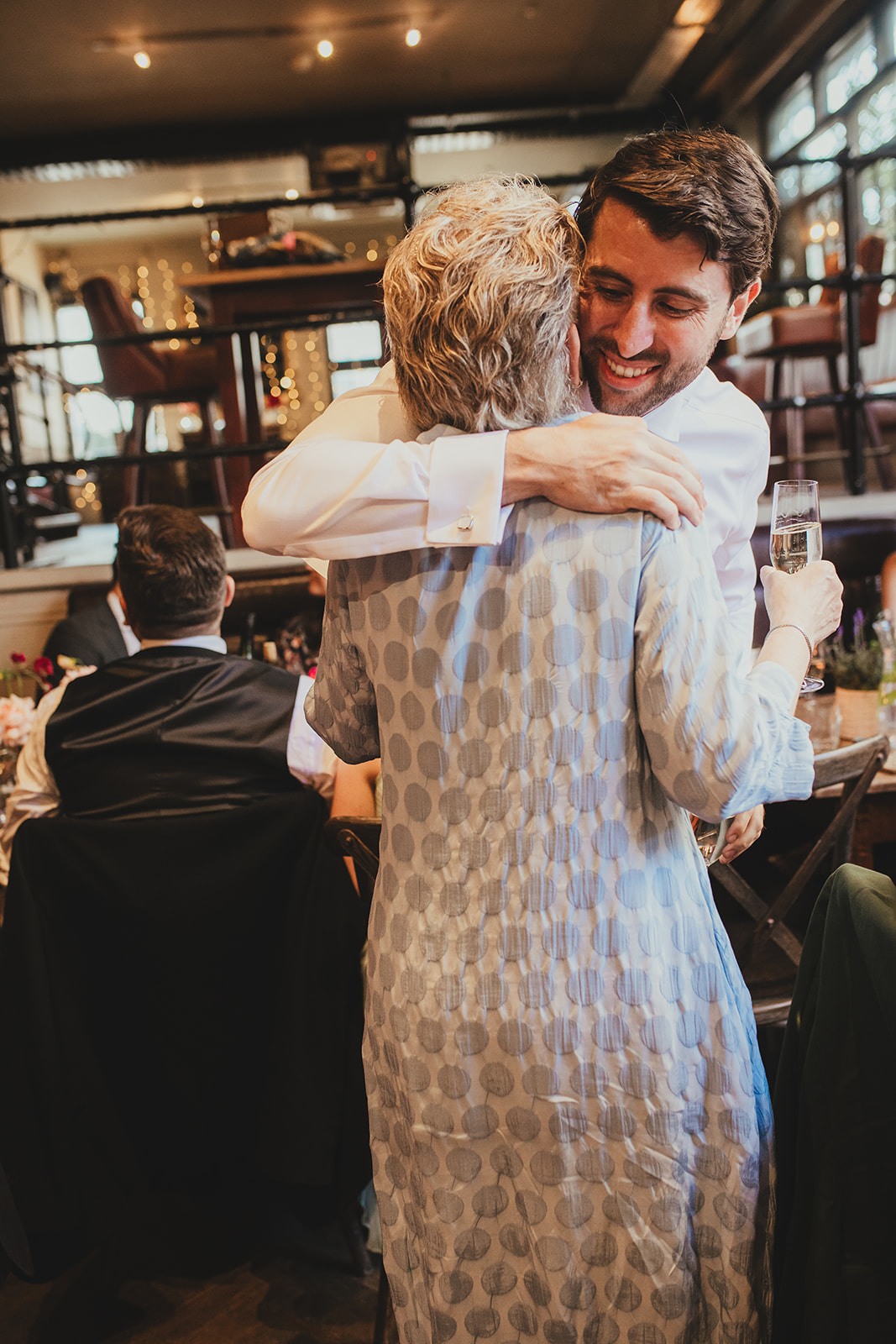 Groom embracing mum at The Depot N7 wedding reception, London wedding