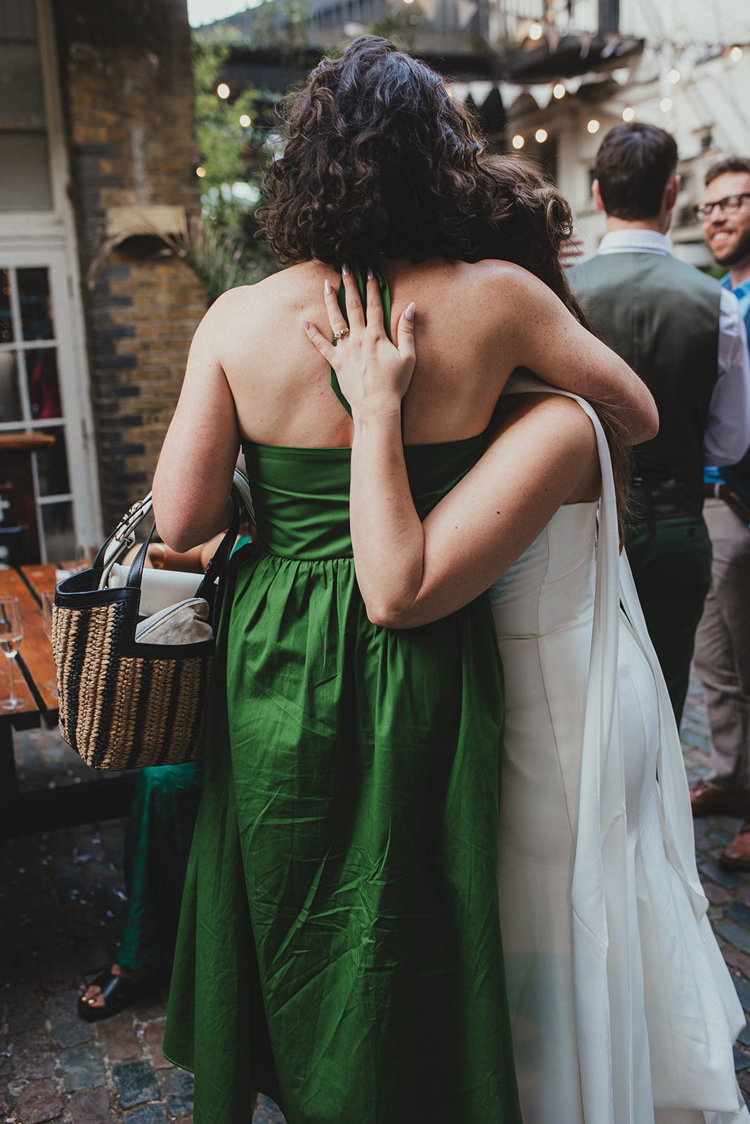Bride embracing guest at wedding reception at The Depot N7, London wedding