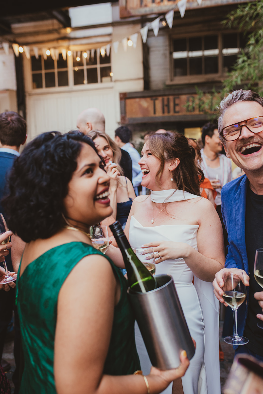 Bride laughing with wedding guests at The Depot N7 wedding reception, London wedding