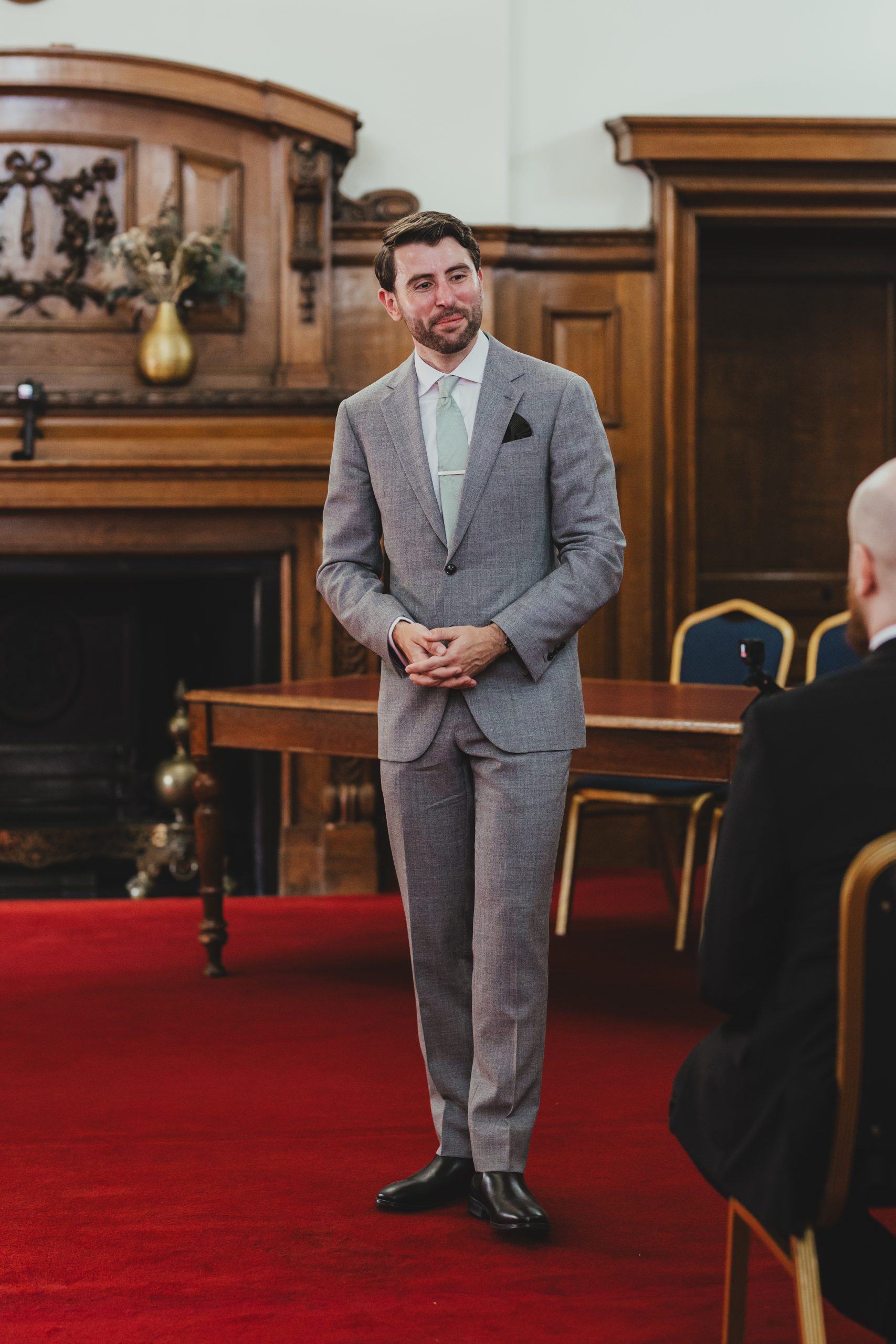 Groom waiting at Islington Town Hall for bride, London wedding