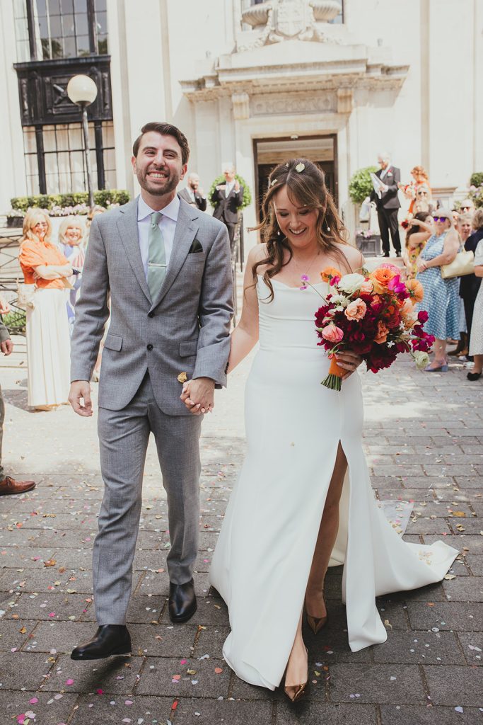 Bride and groom during confetti outside Islington Town Hall, London wedding
