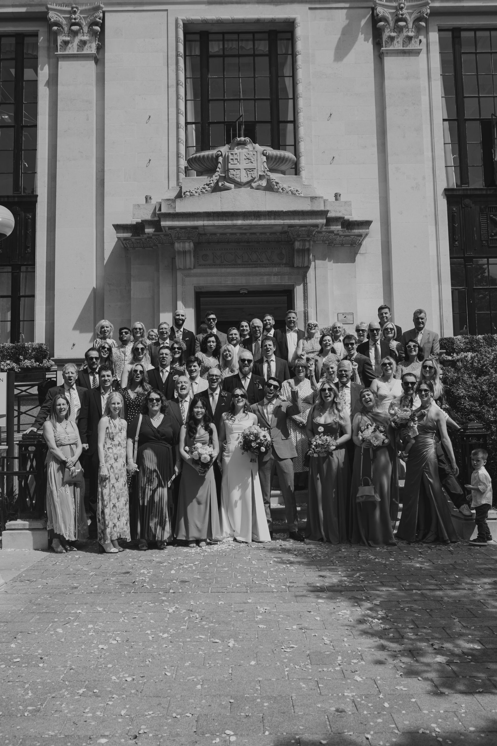 Group photo on the steps at Islington Town Hall, London wedding