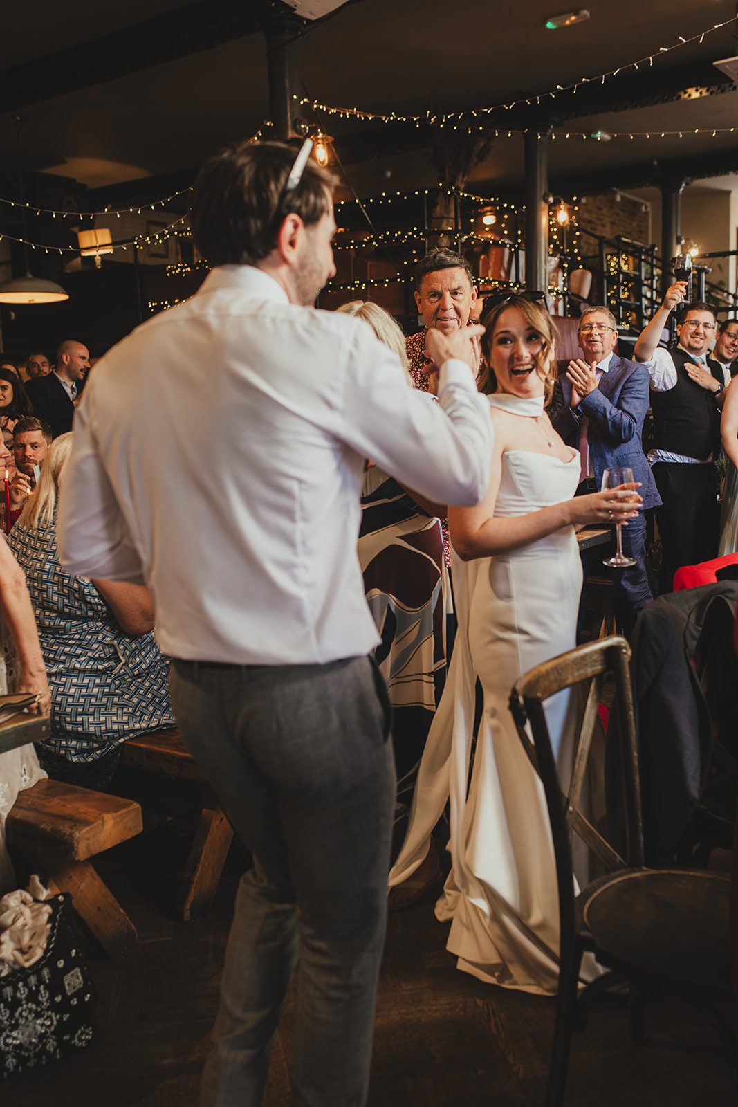Bride and groom entre their wedding reception dinner at The Depot N7, London wedding