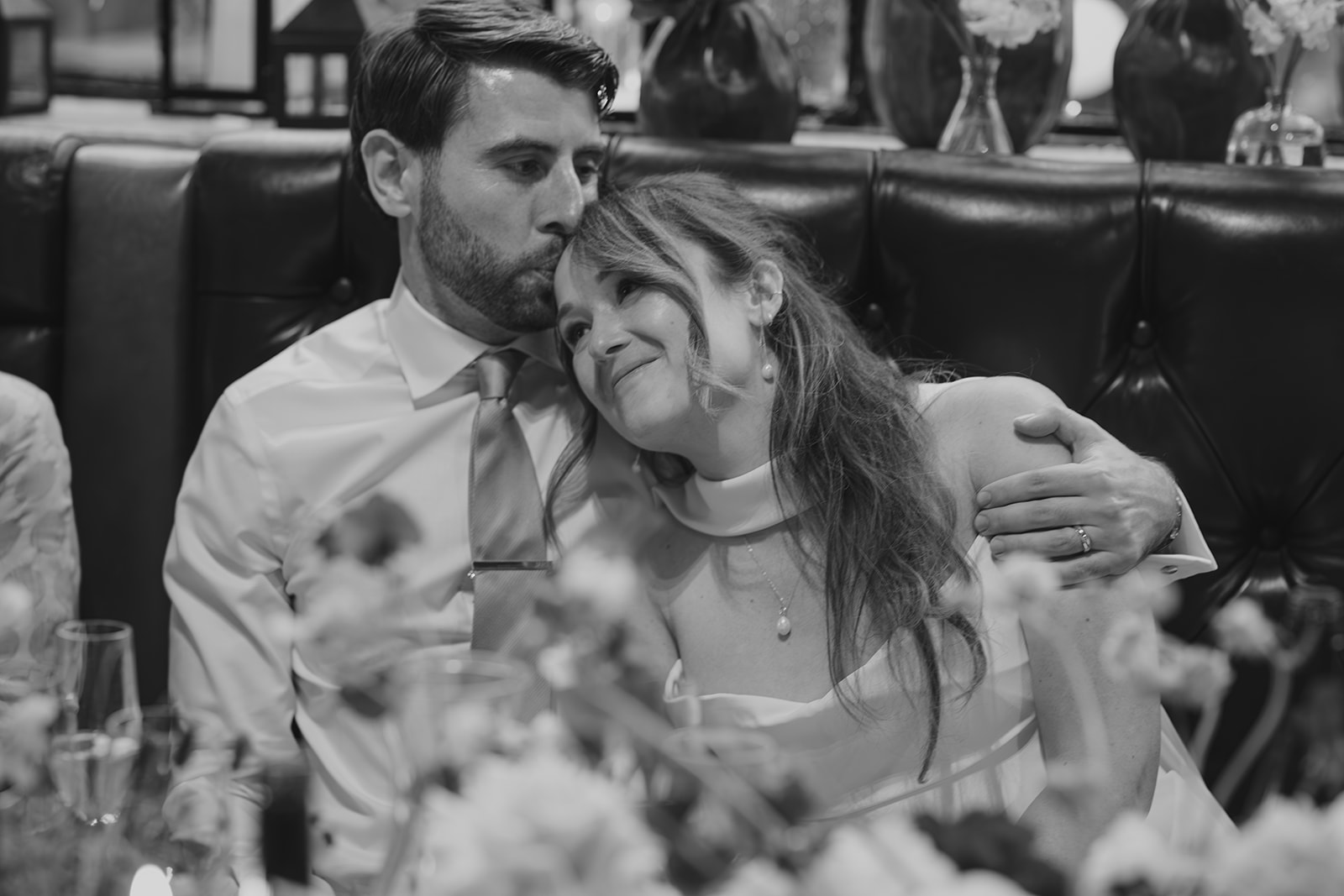 Bride and Groom cuddling during wedding speeches at wedding reception, The Depot N7, London wedding