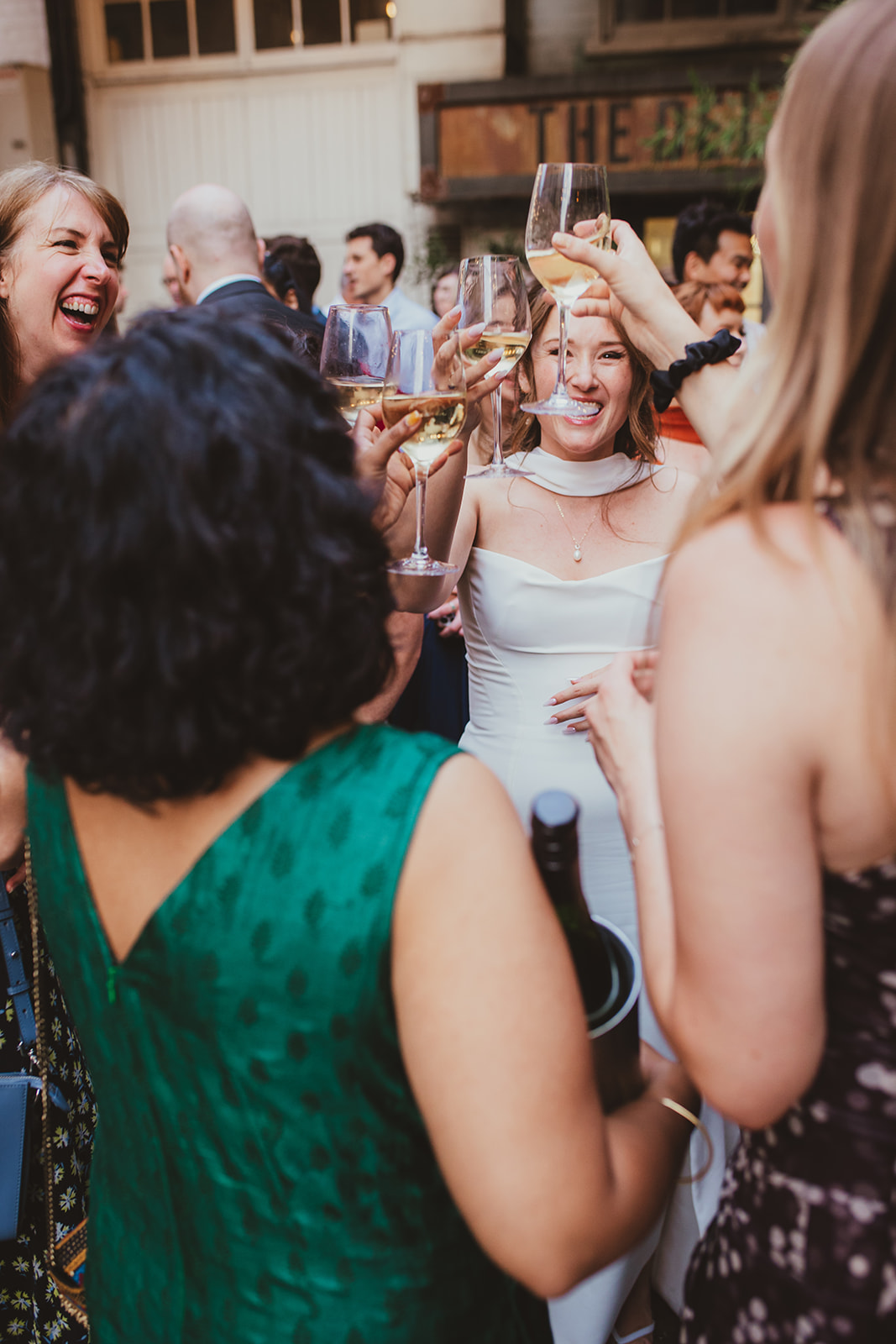 Bride and guests raising their glasses to cheers, The Depot N7 wedding reception, London wedding 
