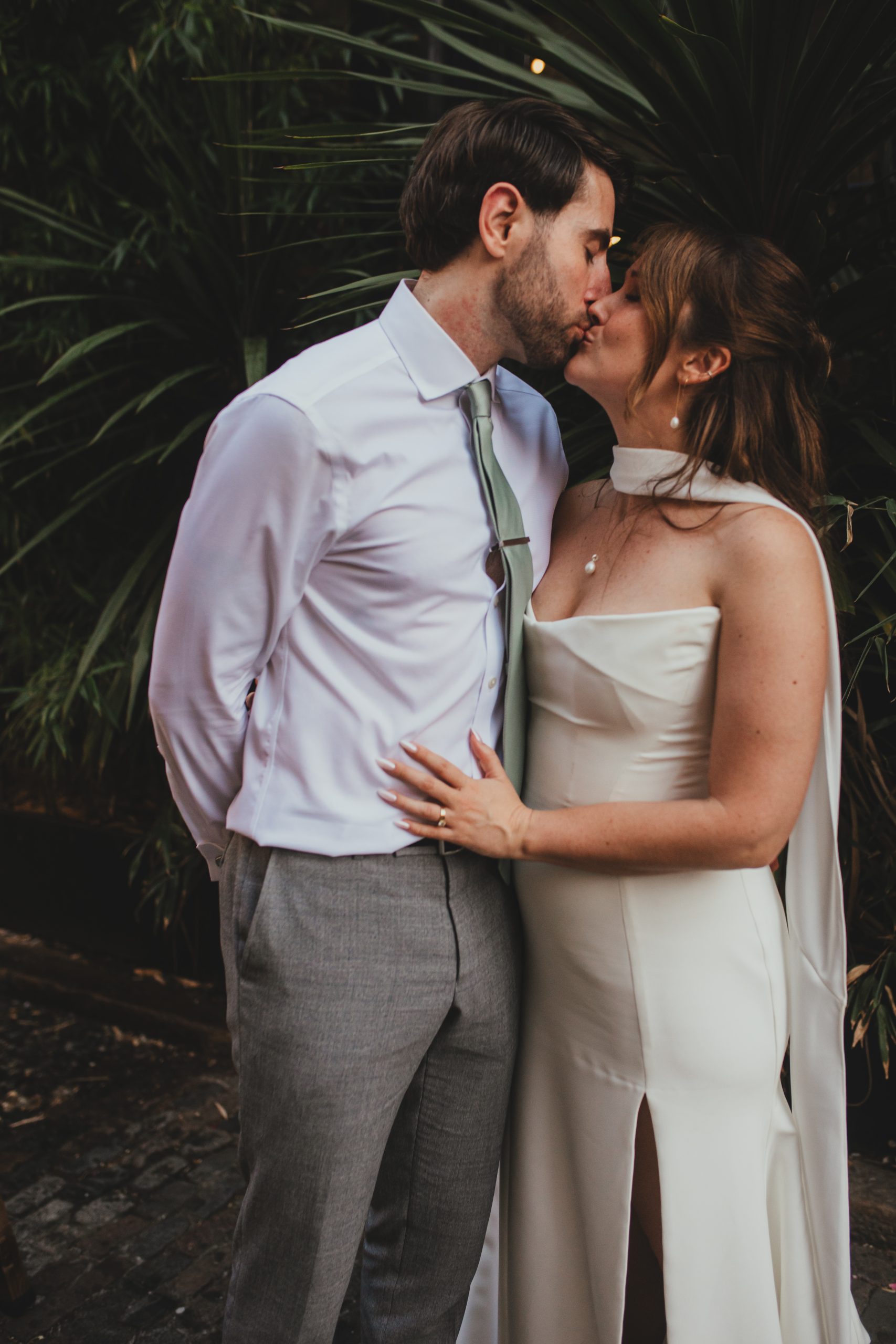 Bride and groom kissing in the courtyard at The Depot N7