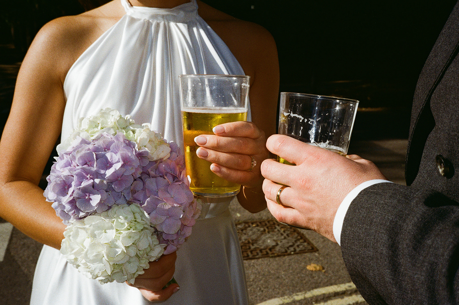 Bride and groom holding pints outside Hampstead pub