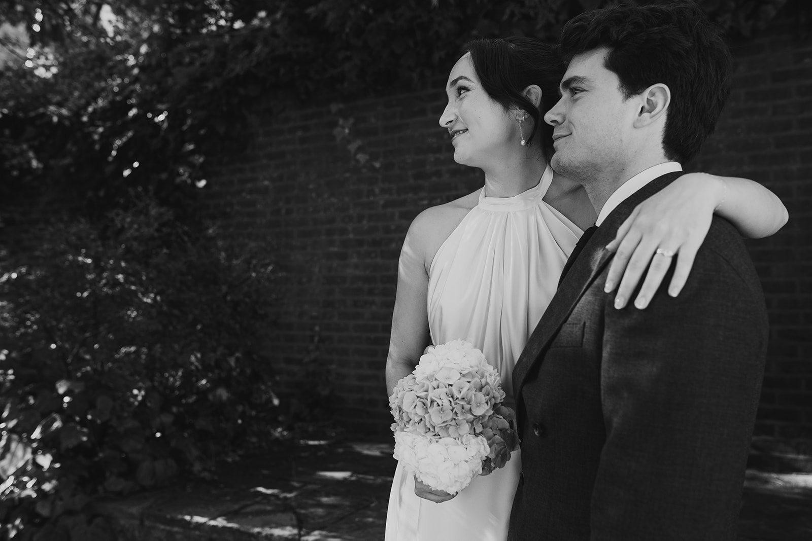 Bride and Groom with bride's arm around groom outside Burgh House in Hampstead Heath