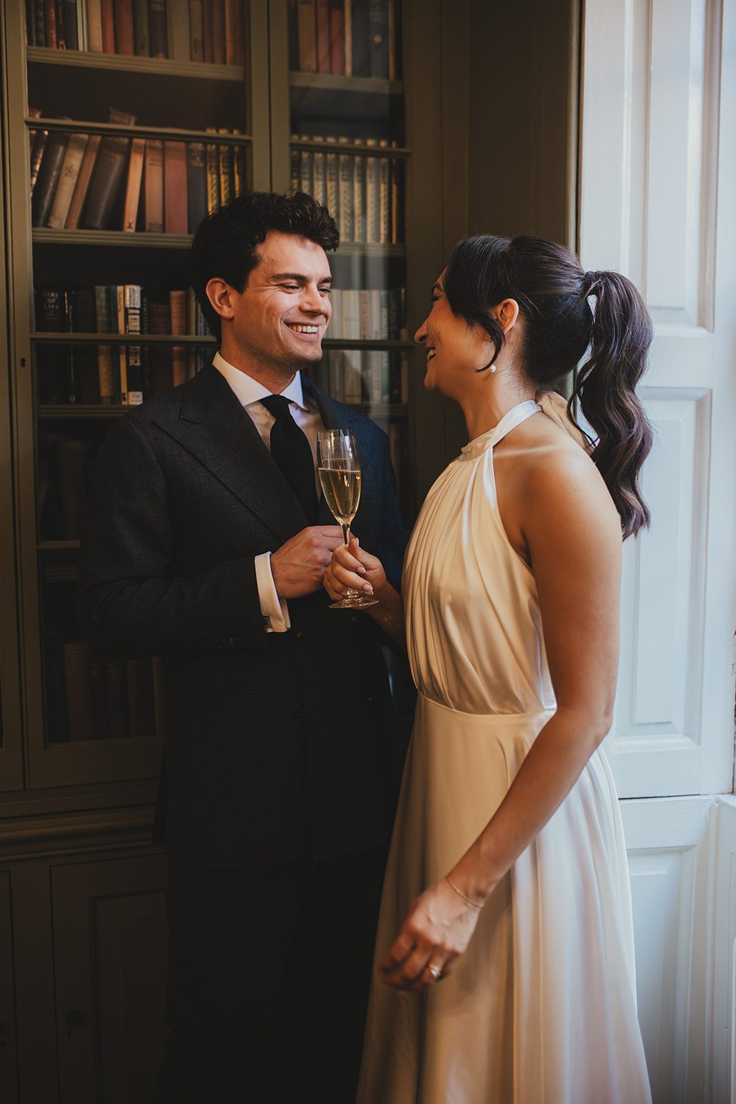 bride and groom in the library at Burgh house chatting
