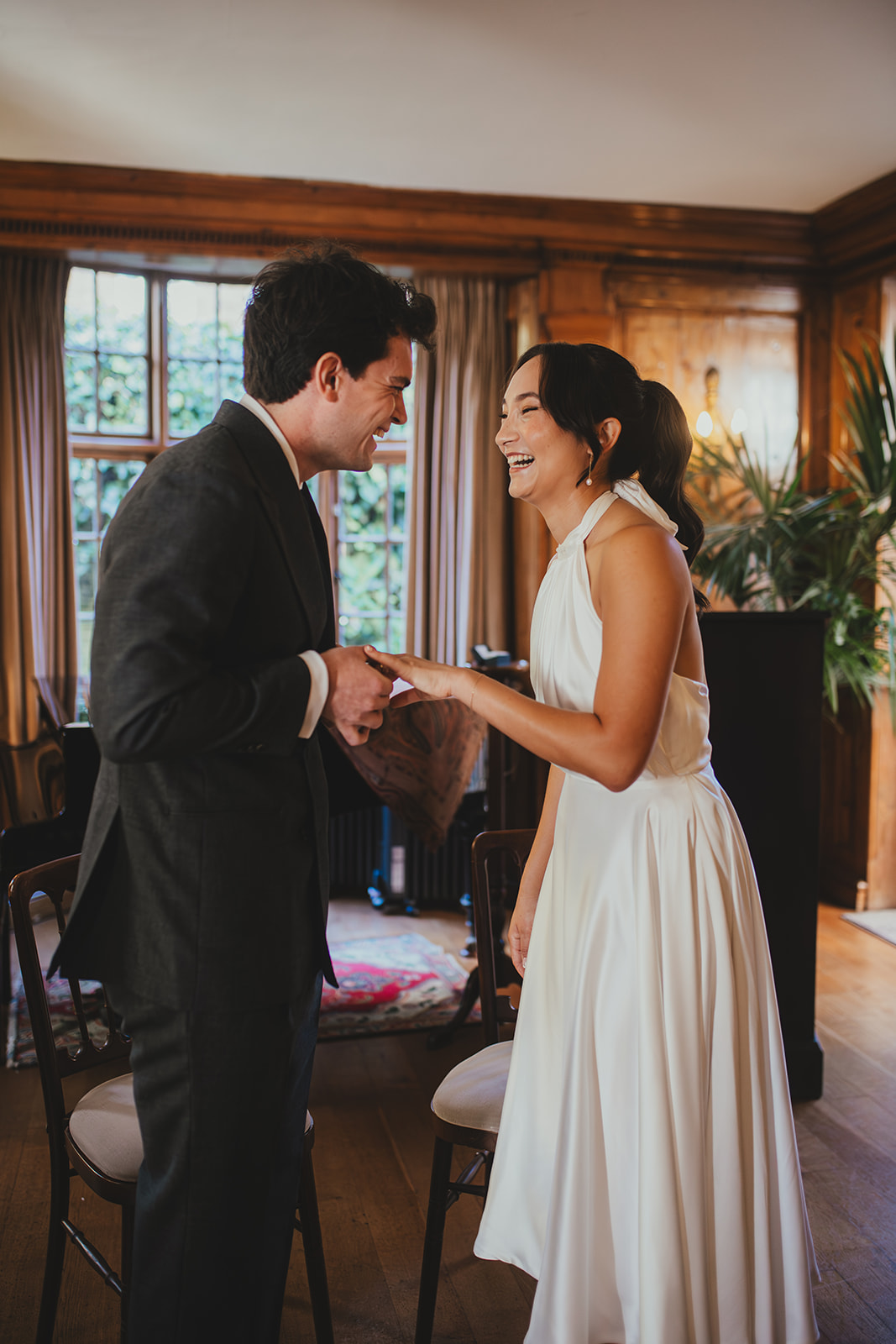 Bride and groom giggle during wedding ceremony 
