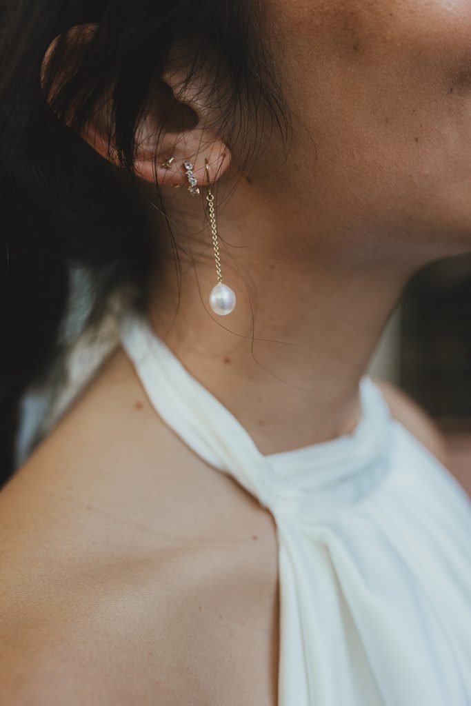 Detail photo of bride's pearl earing