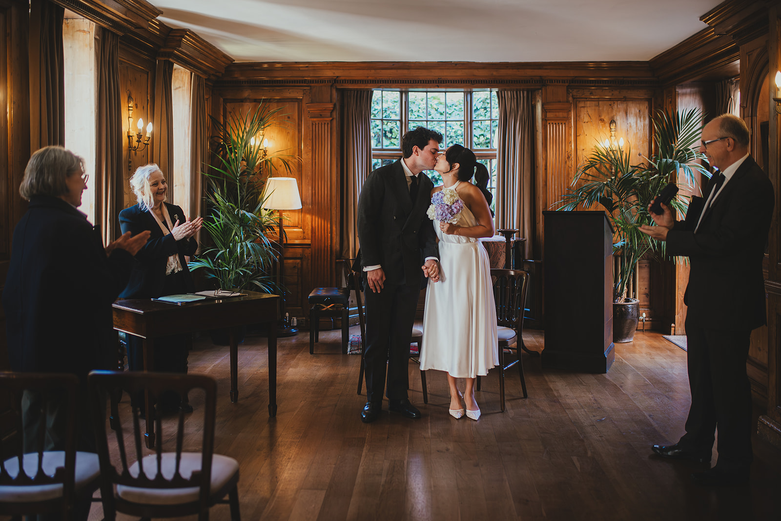 Bride and groom kiss before leaving their ceremony