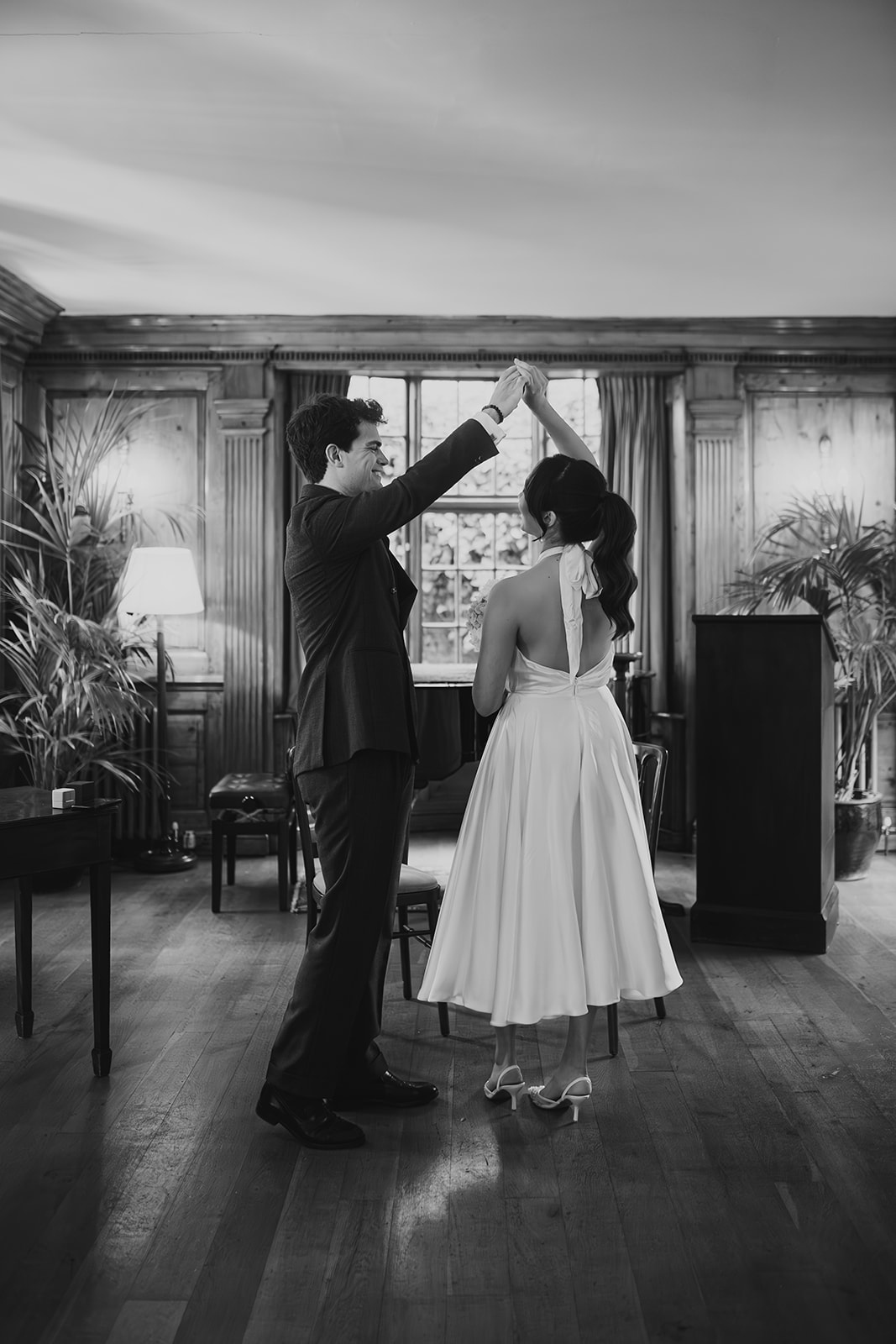 Bride and groom dance after wedding ceremony in the music room at Burgh House 