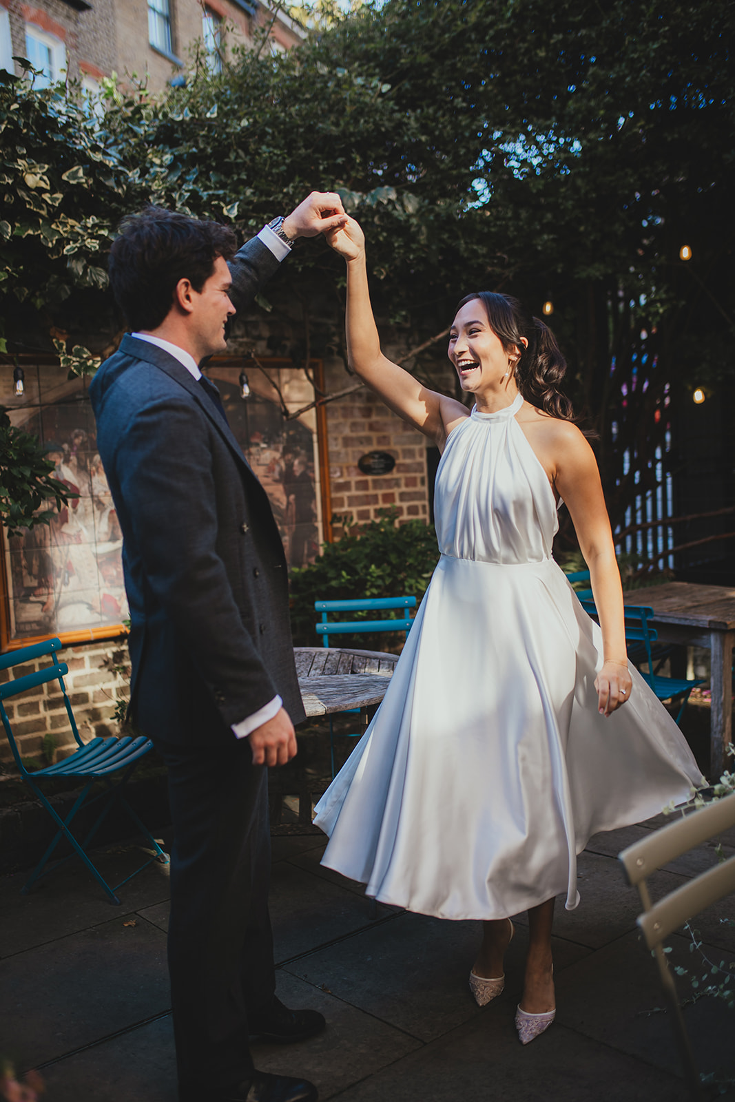 Bride and Groom dancing in Burgh House's courtyard
